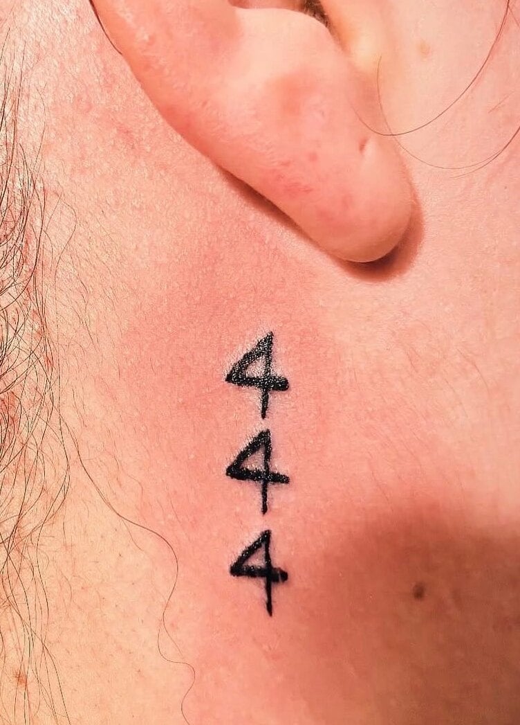 The number 444 stacked vertically behind the ear