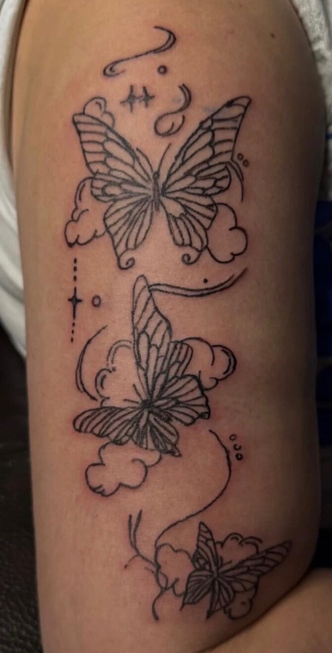 Three butterflies rising through clouds and sparkles in black linework
