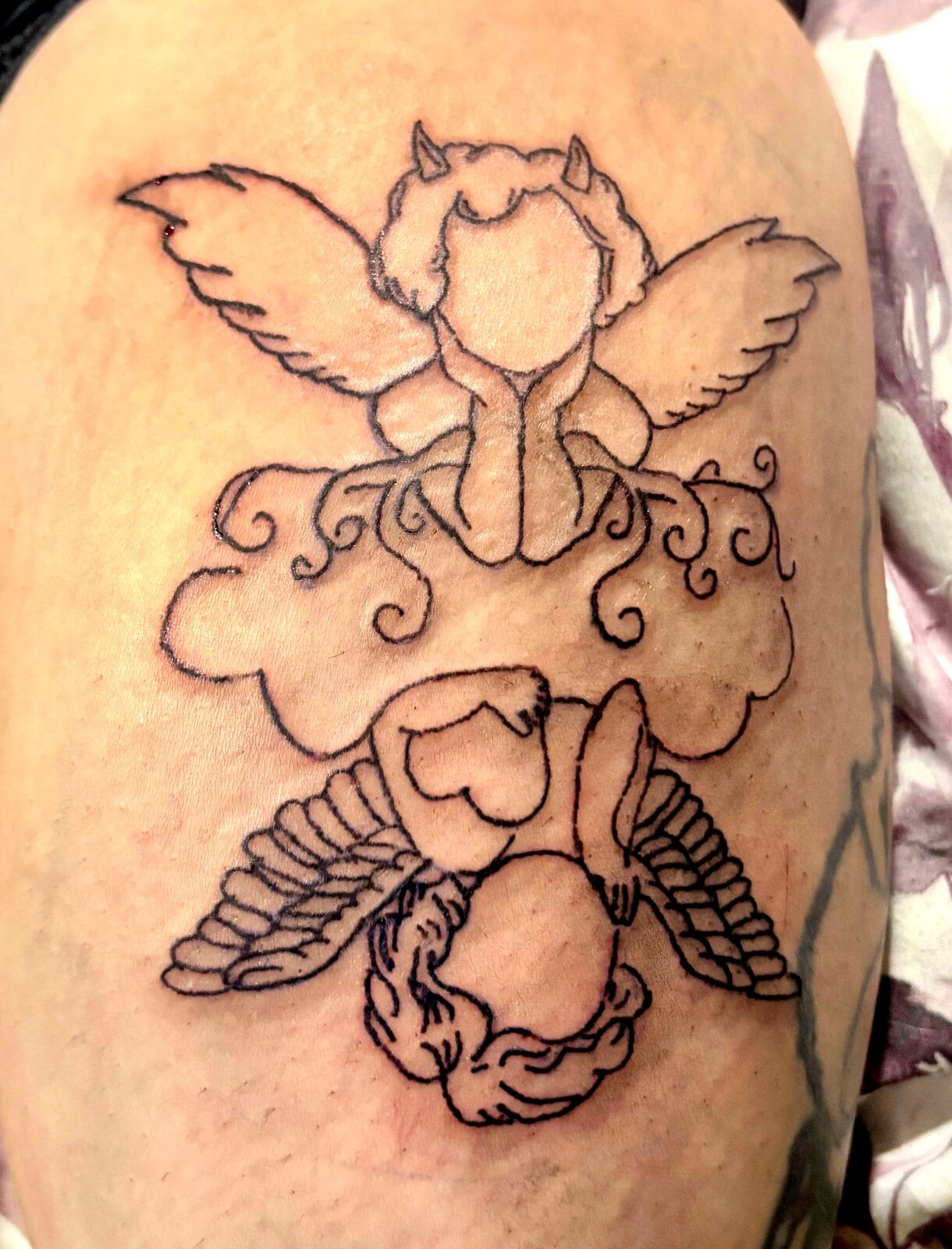 Two mirrored cherubs on a cloud, the top one with small devil horns, in black outline